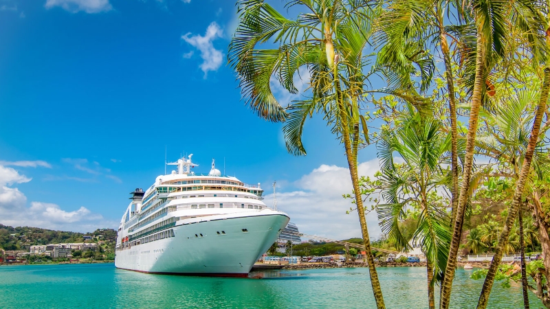 Cruise ship sailing across a crystalclear turquoise sea in the Carribean