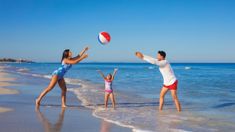 Family playing on the beach in Cuba