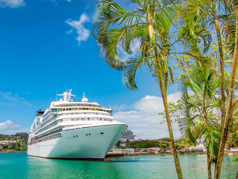 Cruise ship sailing across a crystalclear turquoise sea in the Carribean
