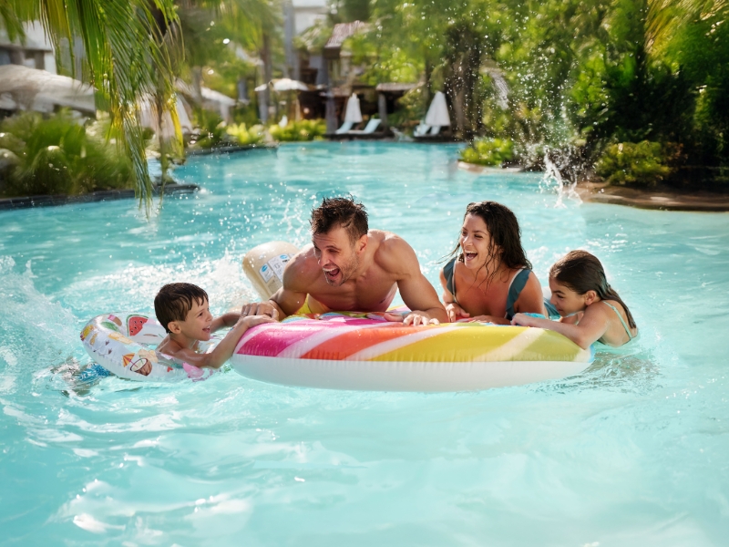 Happy family playing in the pool